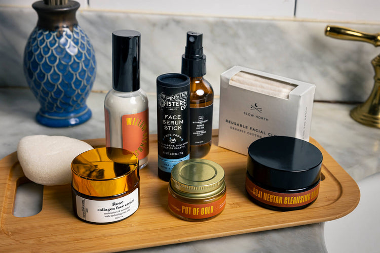 Collection of plant-based skincare products on a counter with mirror