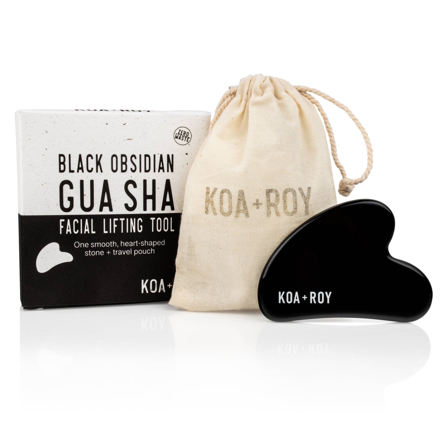 The Stone Gua Sha tool next to the box and bag it comes in