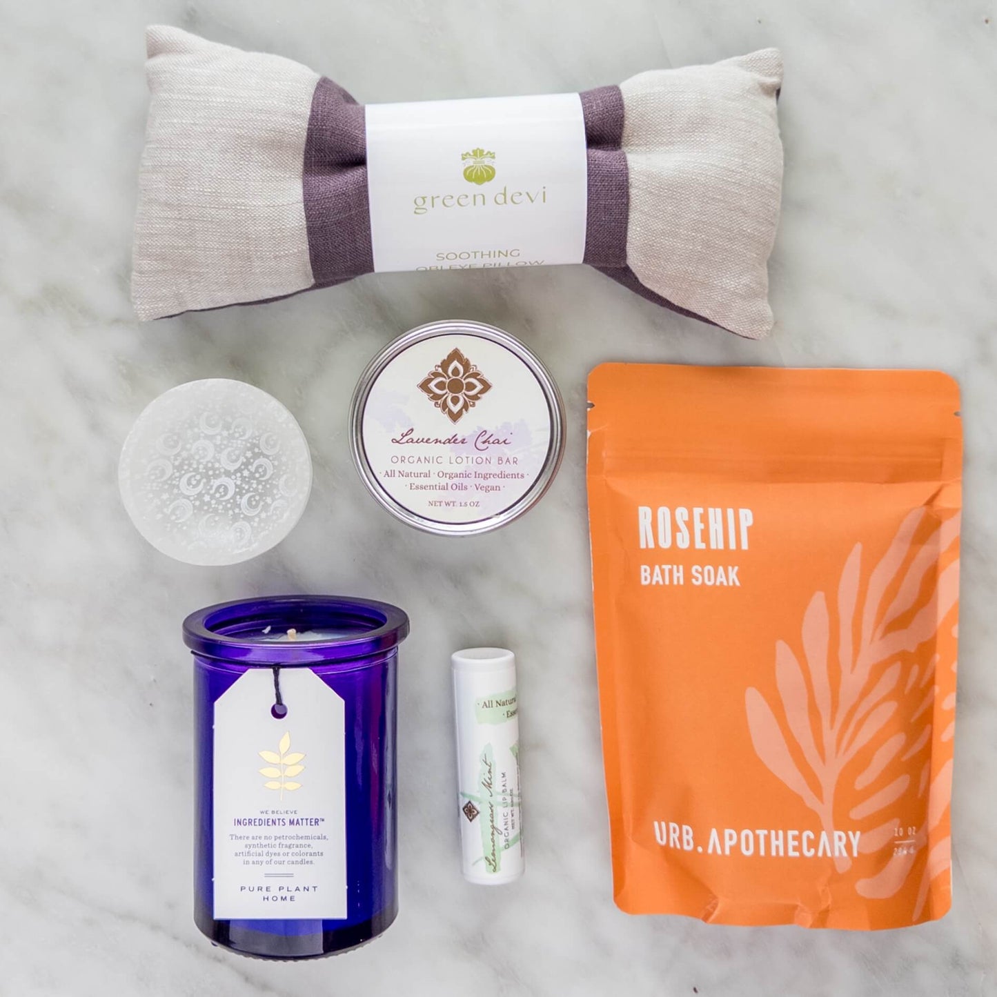 Box contents for the Empty Nester Survival Kit with eye pillow, bath salts, and candle