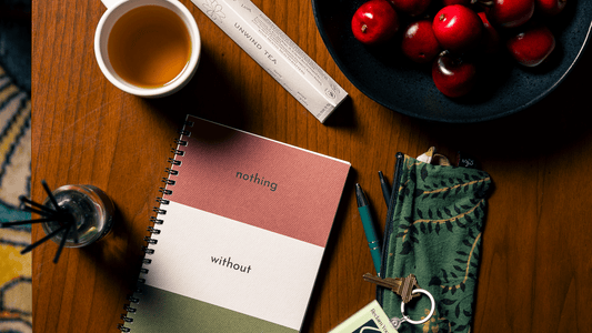 A self-care journal with tea and diffuser