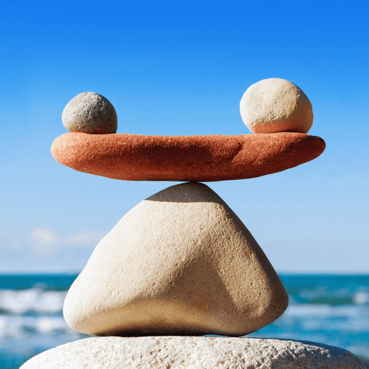 Stones balanced on a rock by the ocean