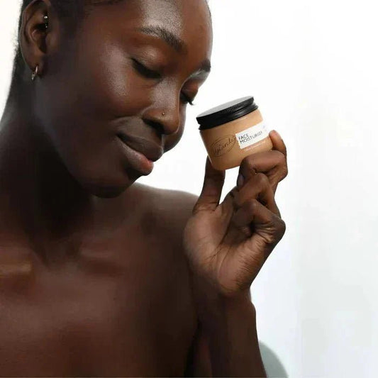 Woman holding a jar of vegan moisturizer for every skin type