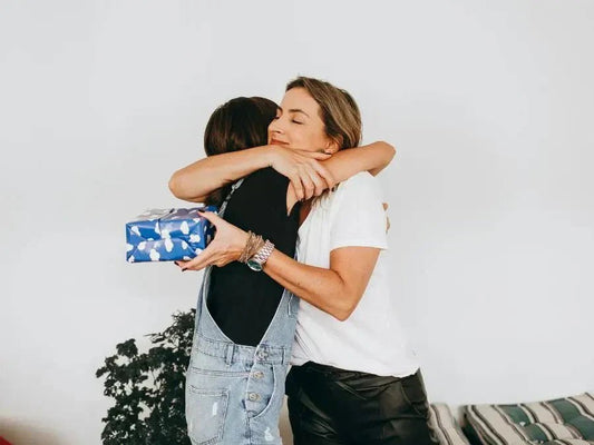 Woman giving a stress relief gift box to her friend