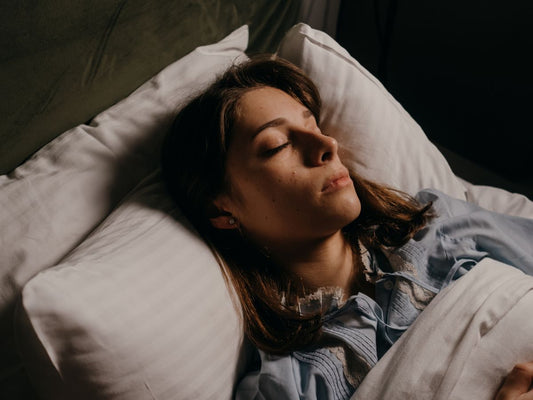 Woman sleeping after using sleep rituals for a better night's sleep
