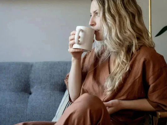 Woman sipping tea as a DIY stress relief technique