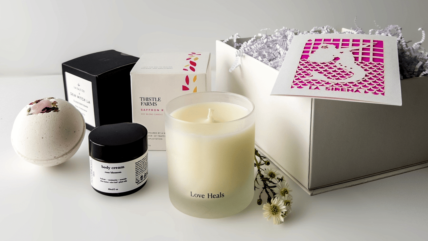 Selected self-care items from Curated Gift Boxes for Women with flowers and a gift box