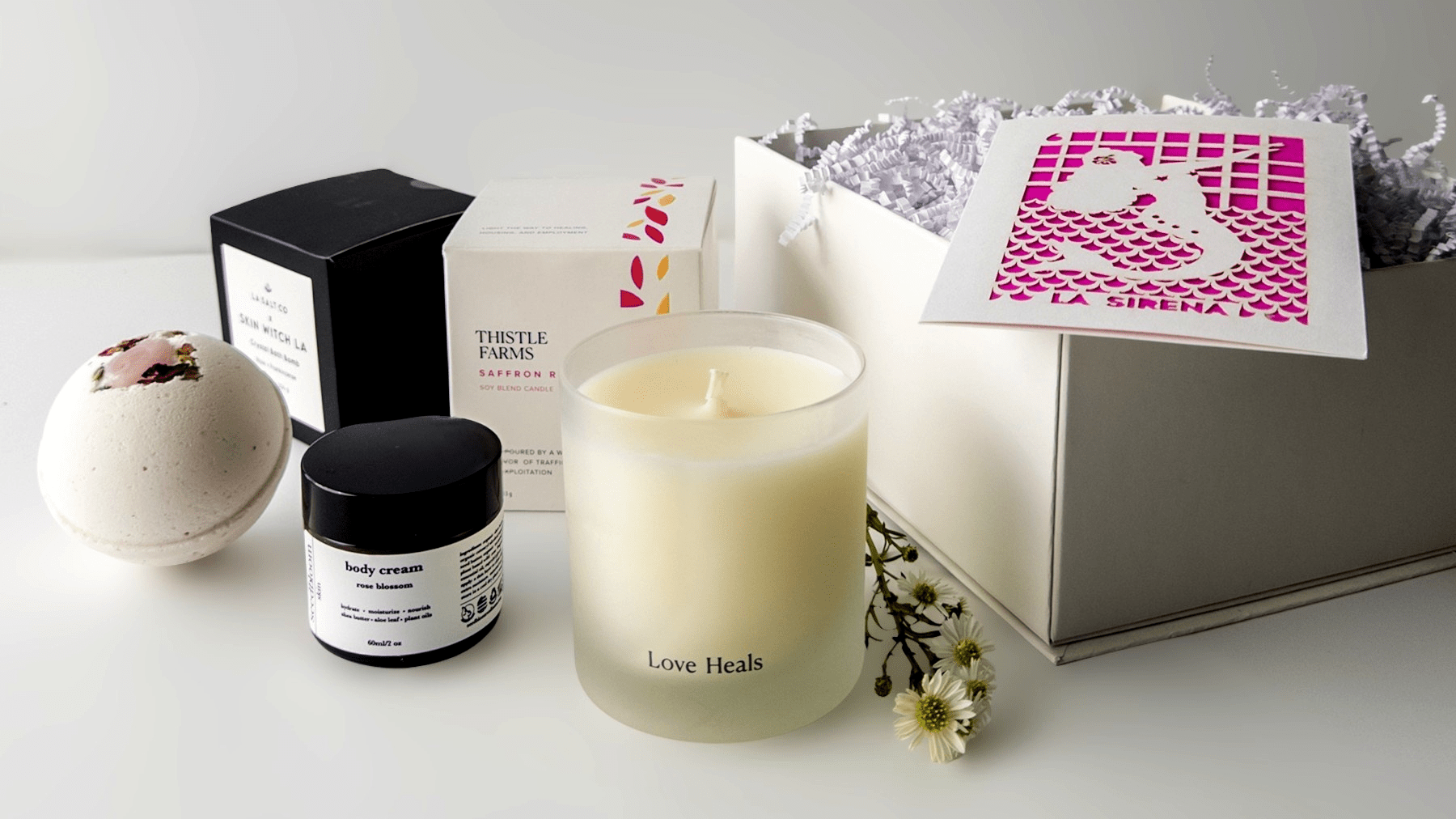 Selected self-care items from Curated Gift Boxes for Women with flowers and a gift box