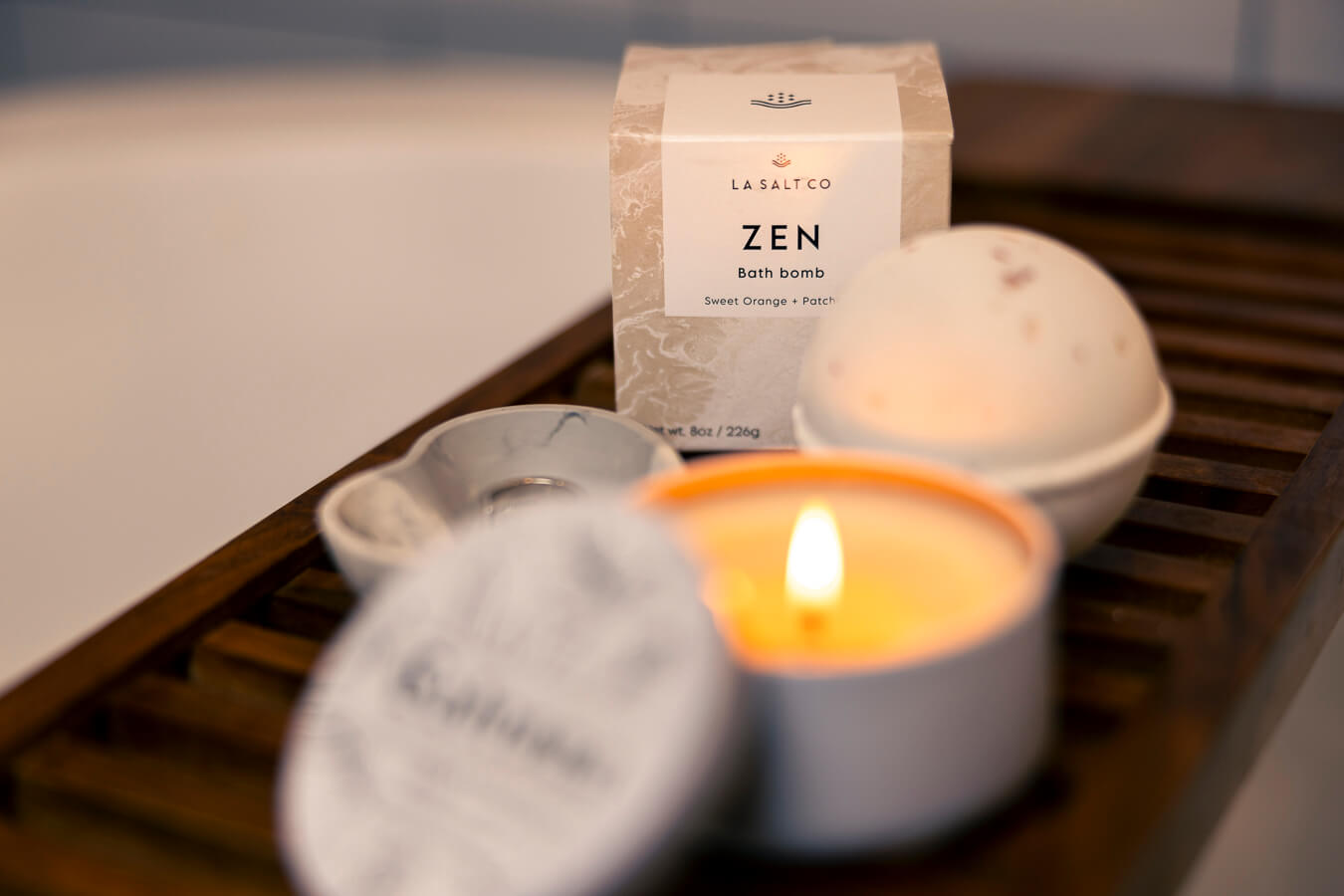 Clean bath and body products on shelf over bathtub