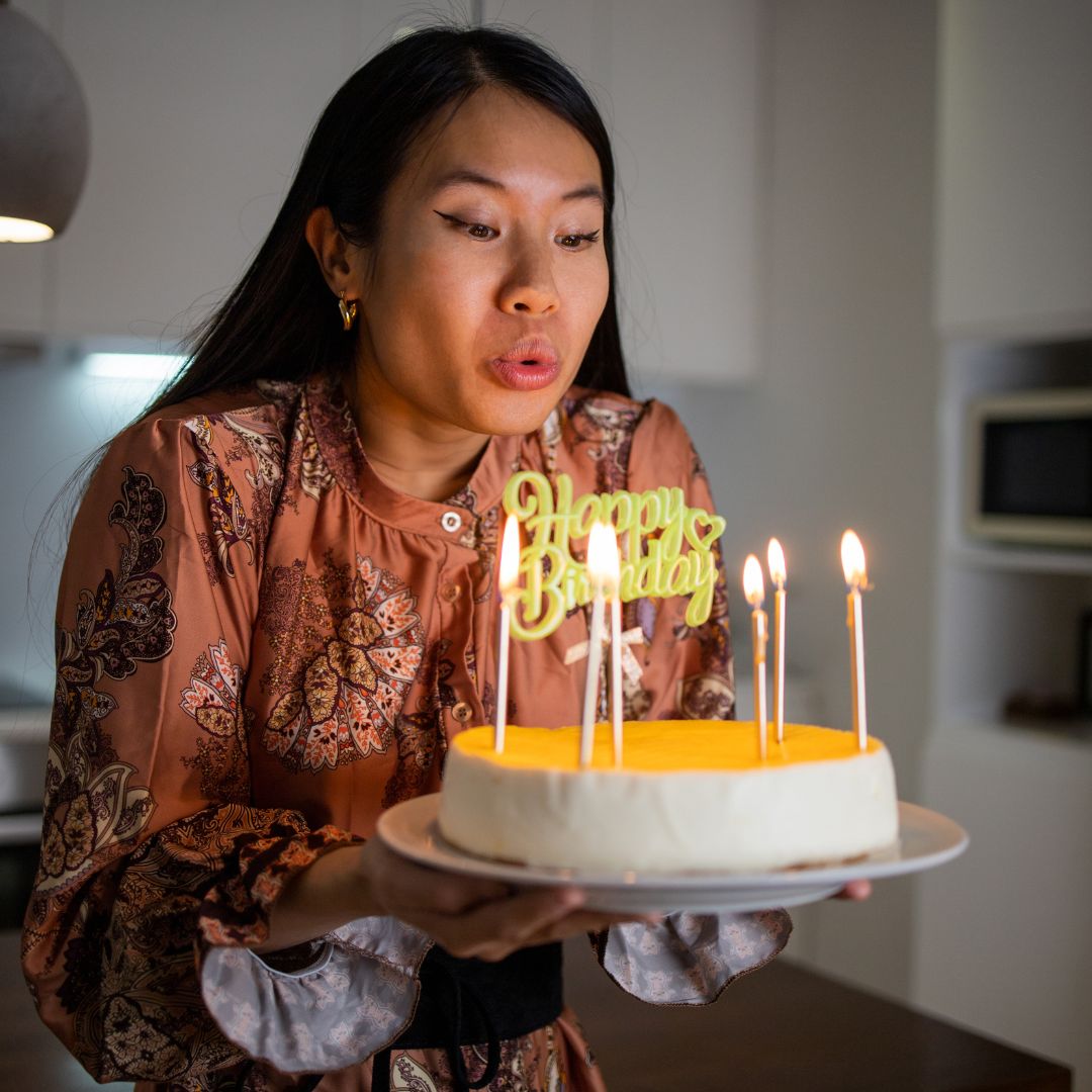 A Birthday Queen celebrating her birthday with a cake and candes