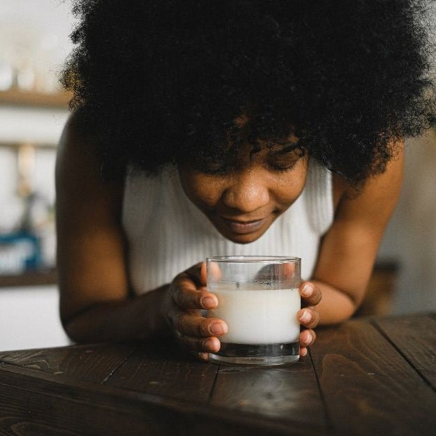 A woman who has everything enjoying an essential oil candle
