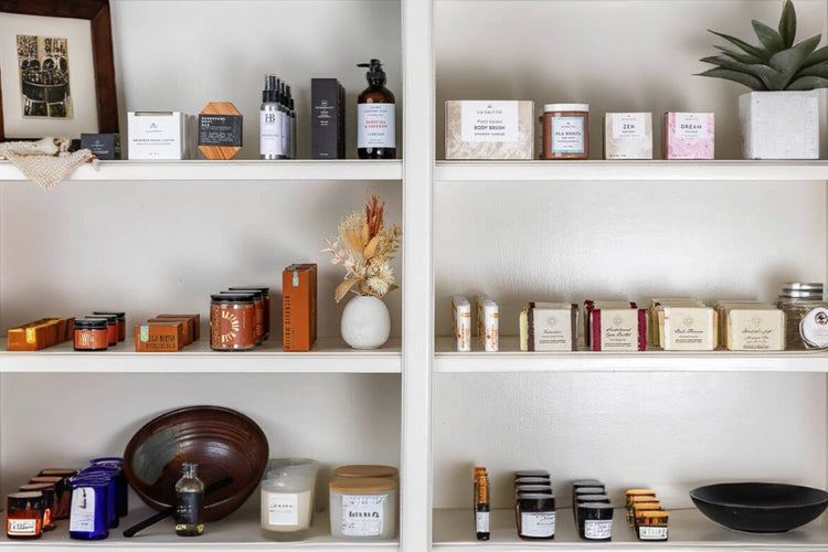 Shelves of self-care and home good products available at Here I Am