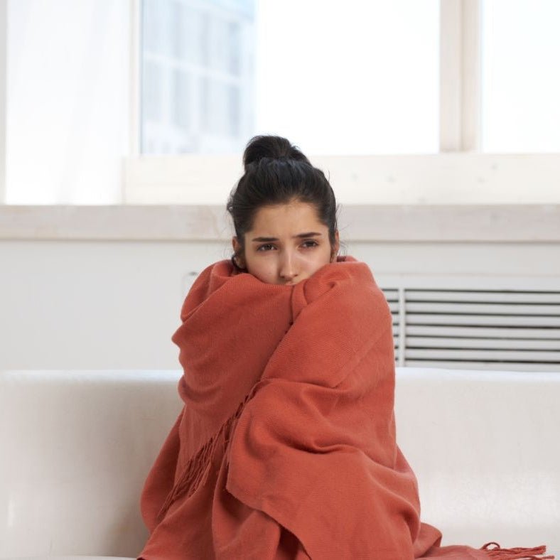A woman who is under the weather and needs a Get Well Gift Box
