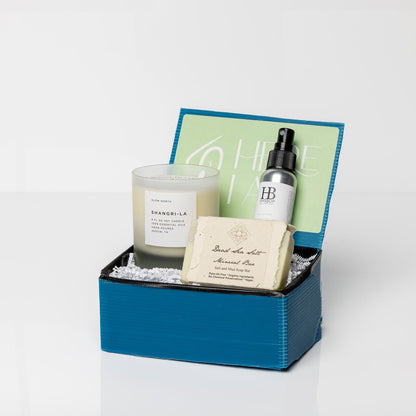 Blue gift box with Dead Sea Minerals Organic Soap, Shangri-La Frosted Candle, and Eucalyptus Shower Mist.