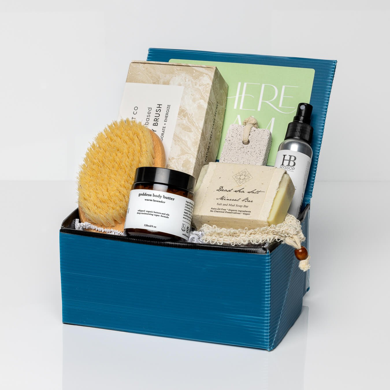 Blue gift box with Dead Sea Minerals Organic Soap, exfoliating soap pouch, body butter, body brush, pumice stone, and eucalyptus mist.