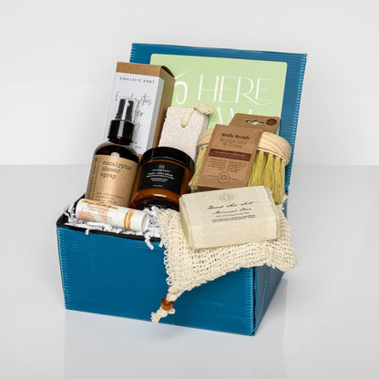 Blue gift box with Dead Sea Minerals Organic Soap, exfoliating soap pouch, body butter, body brush, pumice stone, lip balm and eucalyptus mist.