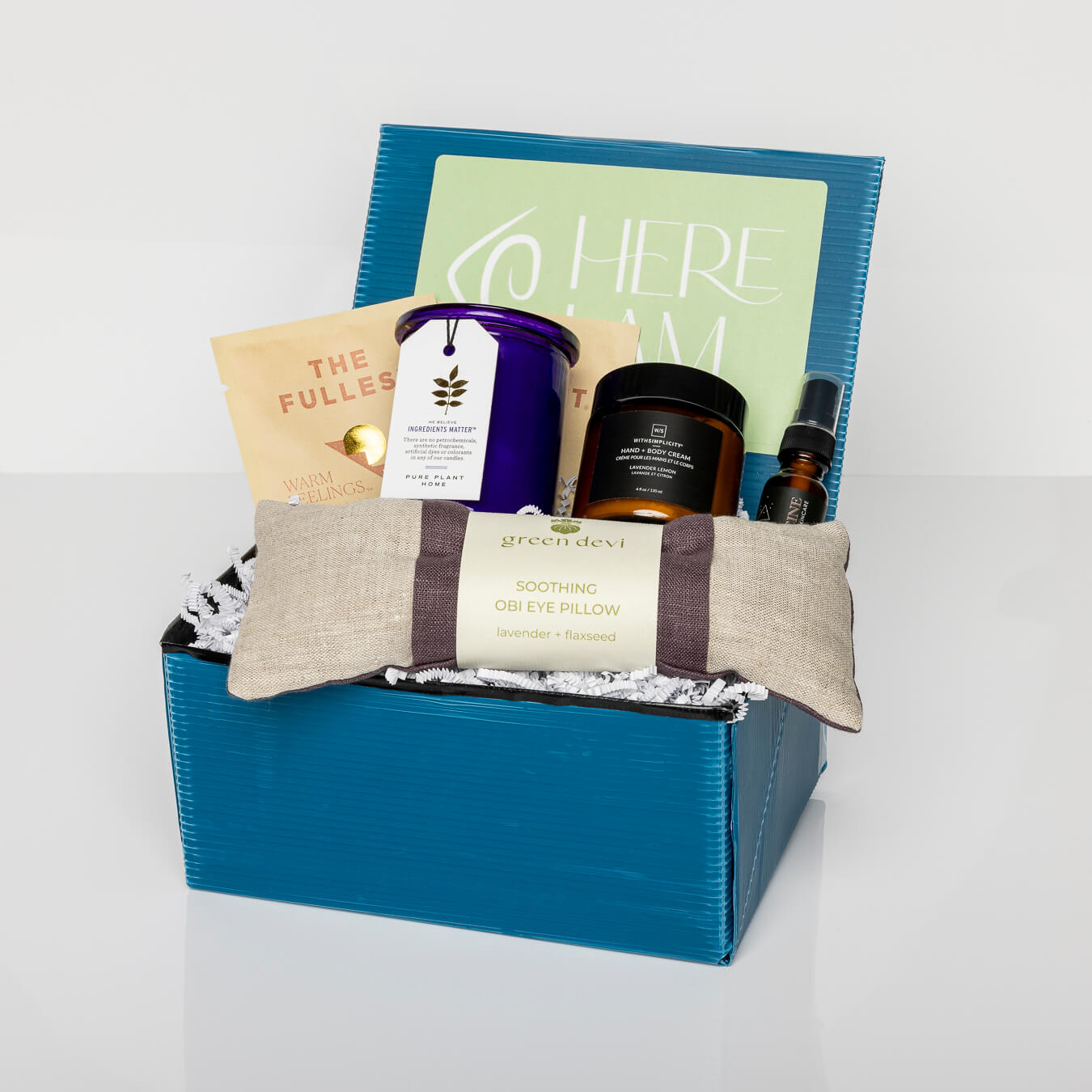 Blue box with French lavender aromatherapy candle, linen lavender eye pillow, saffron latte mix, hand lotion, face mist.