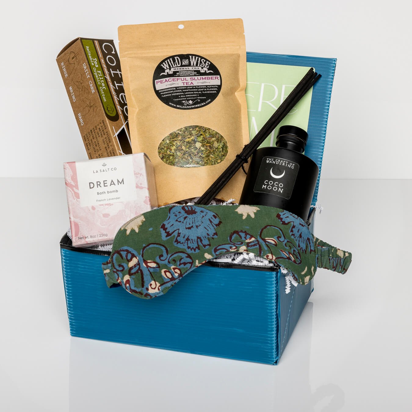 Blue gift box with Dream Bath Bomb, eye mask, Sweet Dreams Aromatherapy, tea and filters, and Reed Diffuser.