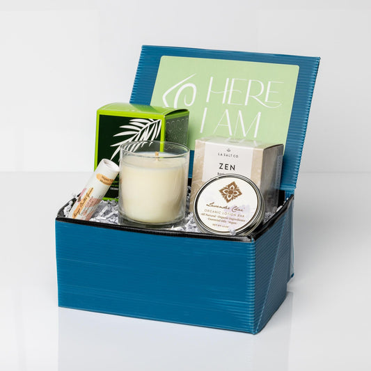 Blue self-care box with Lavender Chai Lotion Bar, Mango Lip Balm, Bergamot Lime Candle, and Zen Bath Bomb.