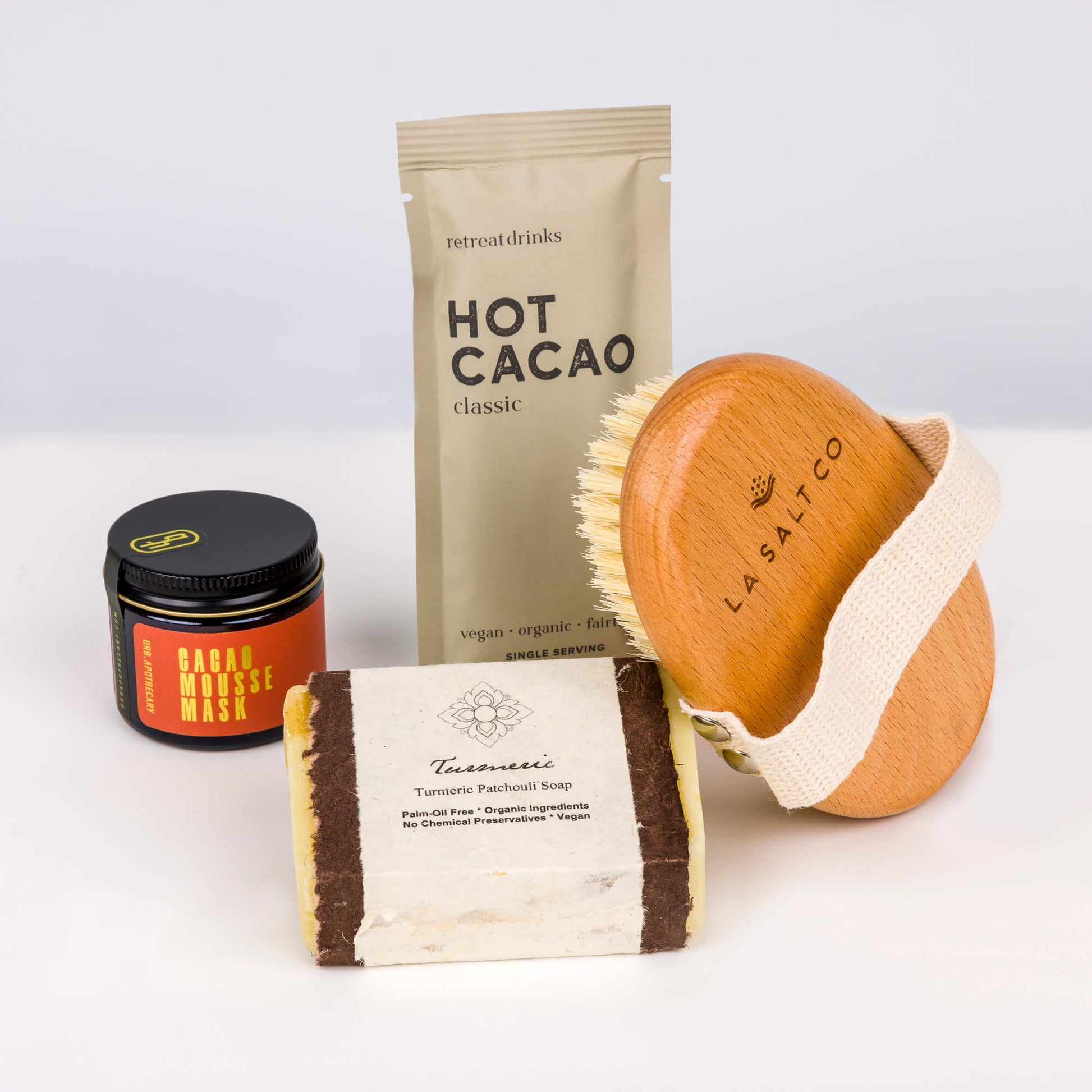 Cacao Cleanse Box from Here I Am, featuring a cacao mousse mask, hot cacao beverage, turmeric soap, and a body brush