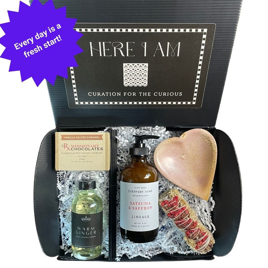 Gift box packed with the artisanal items in the Fresh Start Cleansing Box: hand soap, smudge stick with tray, chocolate truffles, and aromatherapy diffuser