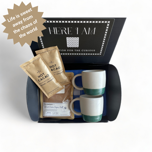 Gift box packed with the key necessities in the Vegan Hot Chocolate Box Set: mugs, cacao, and spiced cocoa rimming sugar