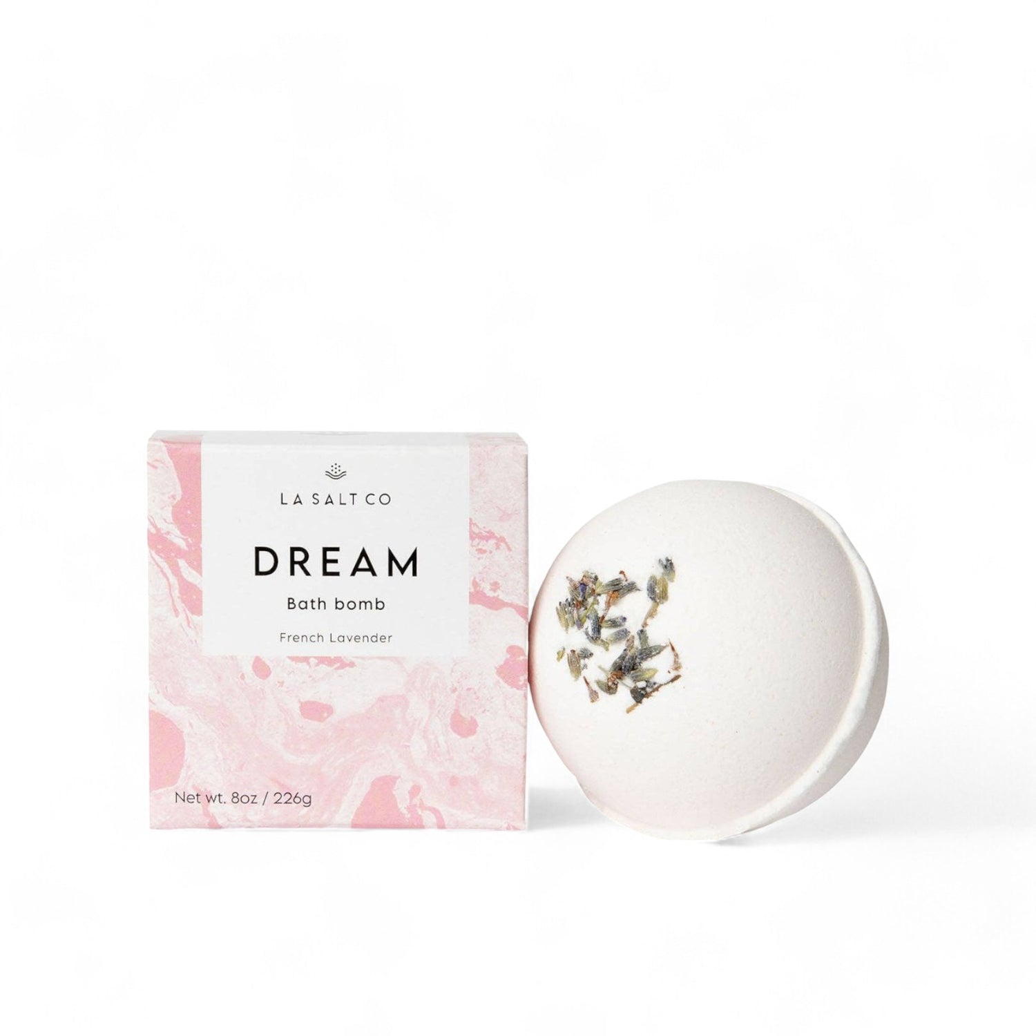 The Dream Bath Bomb next to the pink box it comes in on a white background