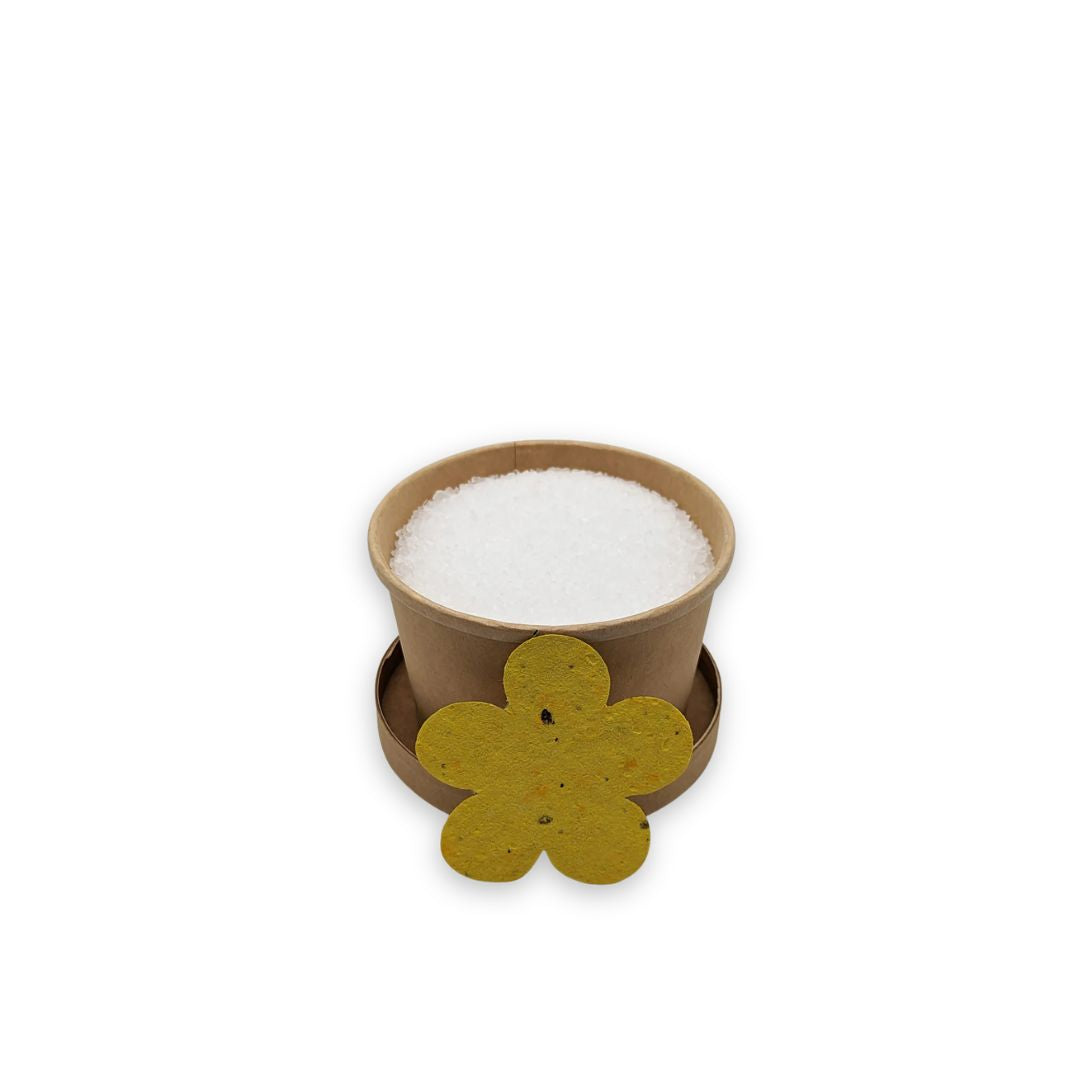 Small brown paper cup of magnesium foot soak infused with Turmeric and Ginger.