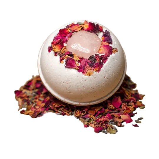 Perfect for a Valentine's Day gift box, the Rose Bath Bomb with rose quartz crystal and dried flowers on a beige background