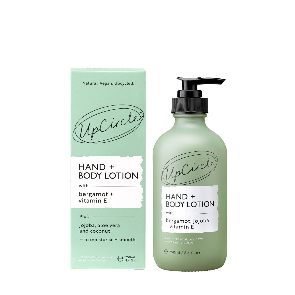 UpCircle Hand & Body Lotion in a frosted sage green pump bottle next to its matching light green and white packaging box, on a plain white background.