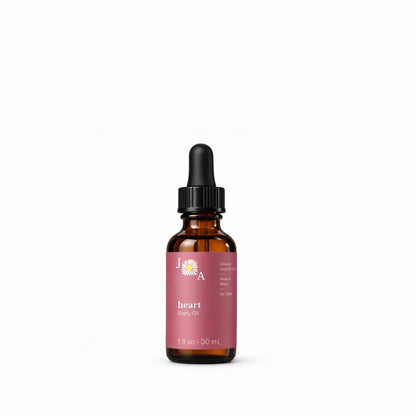An amber glass dropper bottle of heart body oil with a black dropper cap and a dusty pink label, centered on a plain white background.