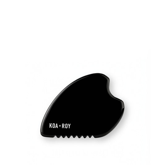 Stone Gua Sha tool for body massage in black obsidian stone on white background