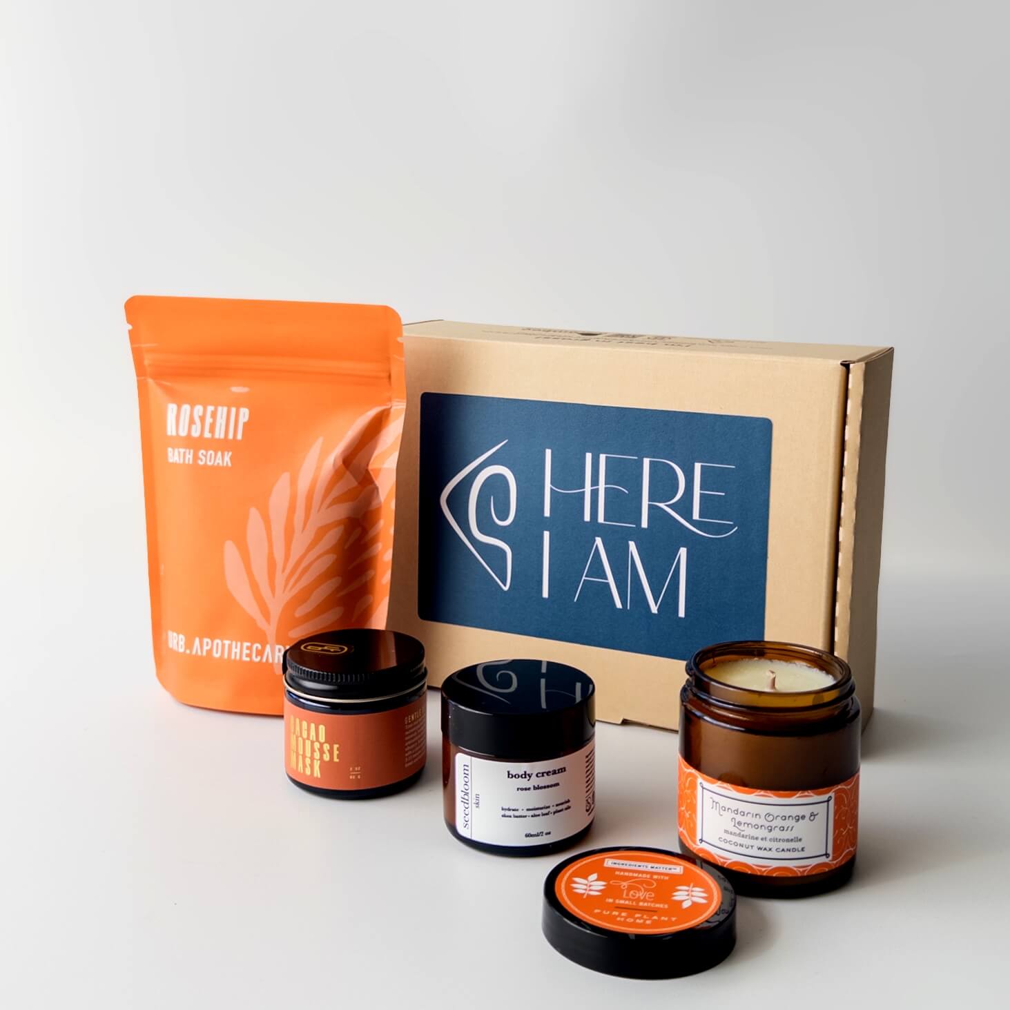 Box set of self-care products in the Blissful Bath box with the Cacao mask, mandarin orange lemongrass candle, floral hand lotion and rosehip bath soak.