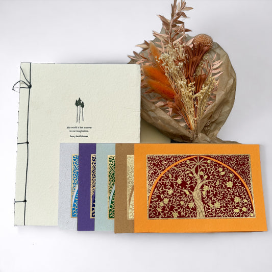 Selections from this Care Package: dried flowers, paper journal, screen printed notecards on white background