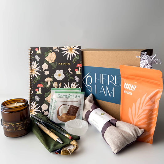 Gift box contents for the Empty Nest Gift with eye pillow, bath salts, candle, journal, and hot cocoa.