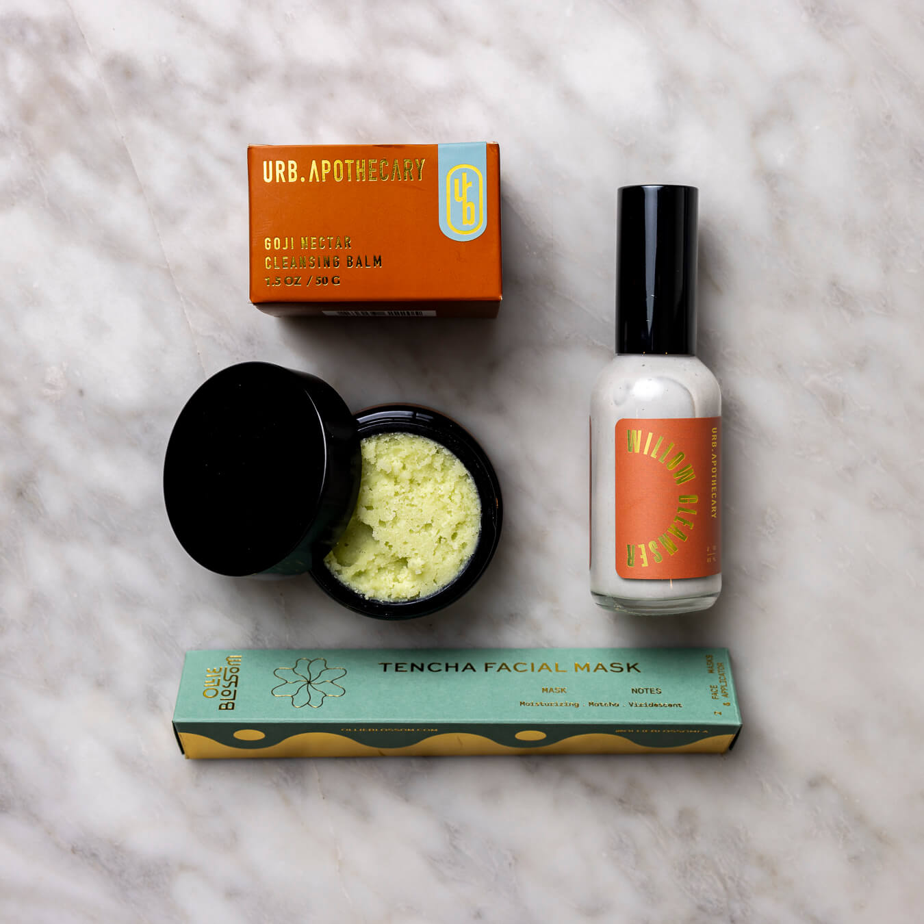 Goji Nectar Cleansing Balm, Tencha Facial Mask, and Willow Cleanser on a white background.