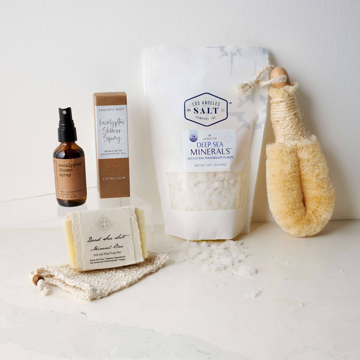 Contents in the Magnesium Bath Box, including Zechstein sea salts, body brush, shower spray, and soap.