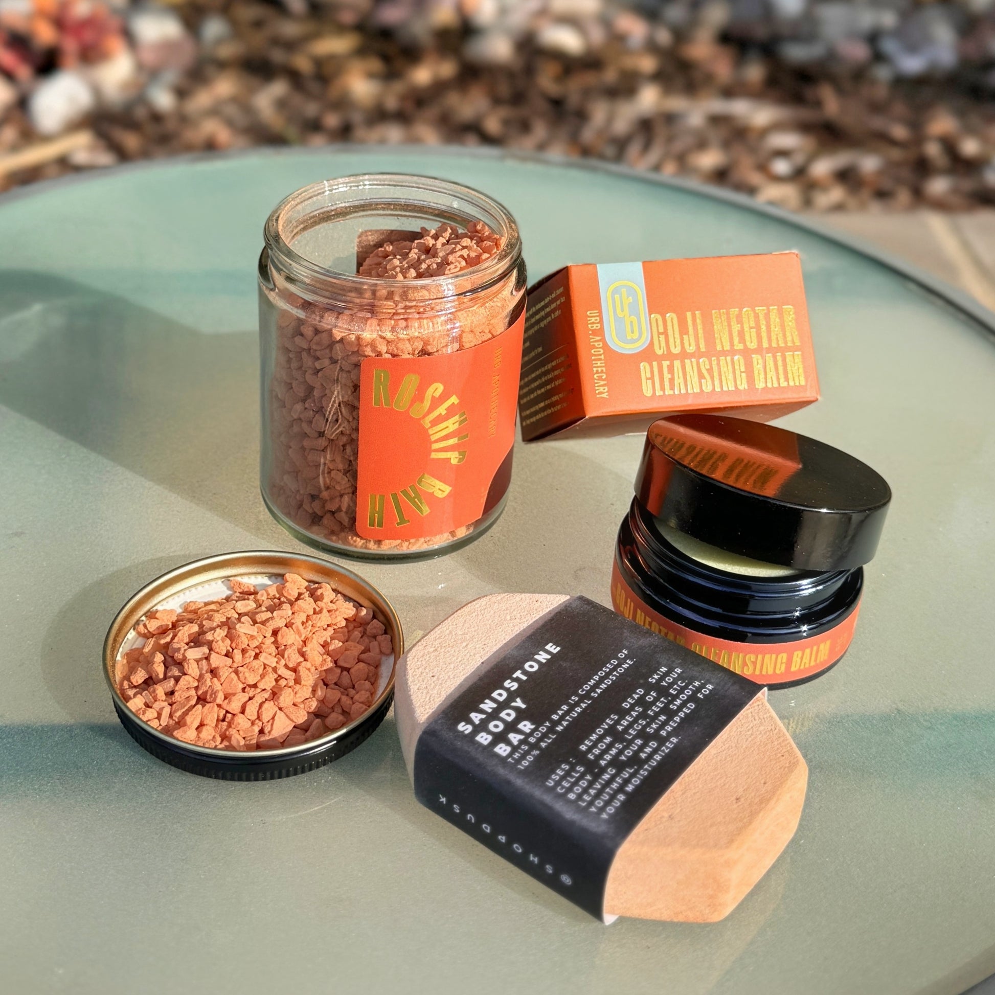 The products included in the Scrubbed Self-Care box on a table outside