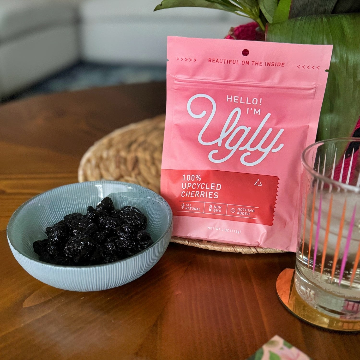 A dish and the bag of dried cherries from the Ugly Company next to a cocktail