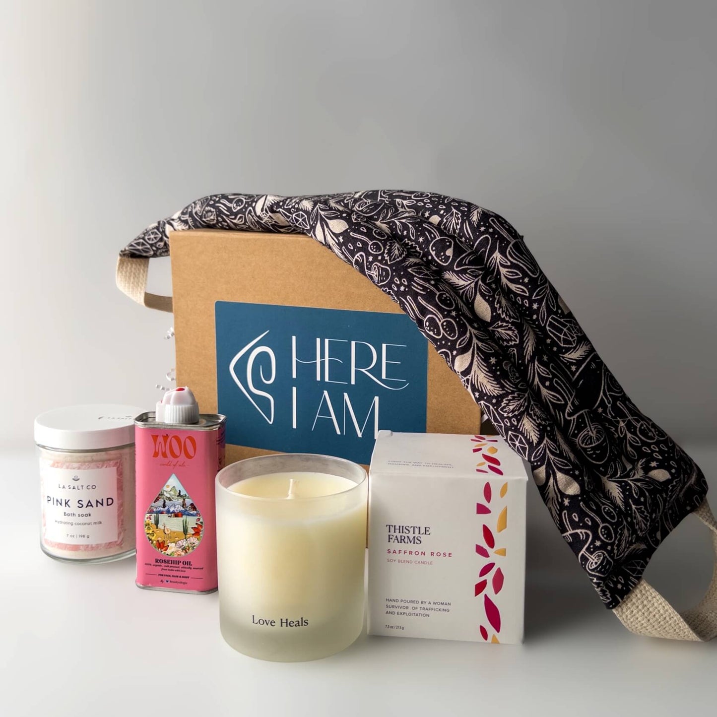 Contents of the Rest & Relaxation Gift Box including weighted neck wrap, candle, oil, and Pink Sand bath soak
