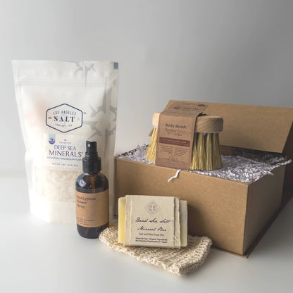 Contents in the Magnesium Bath Box, including Zechstein sea salts, body brush, shower spray, and soap.