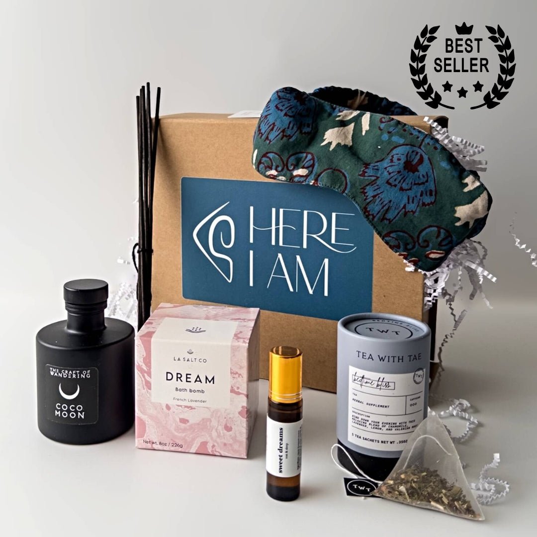 Items from the Sweet Sleep Natural Sleep kit including bath bomb, eye mask, aromatherapy, and tea in front of a wrapped gift box. 