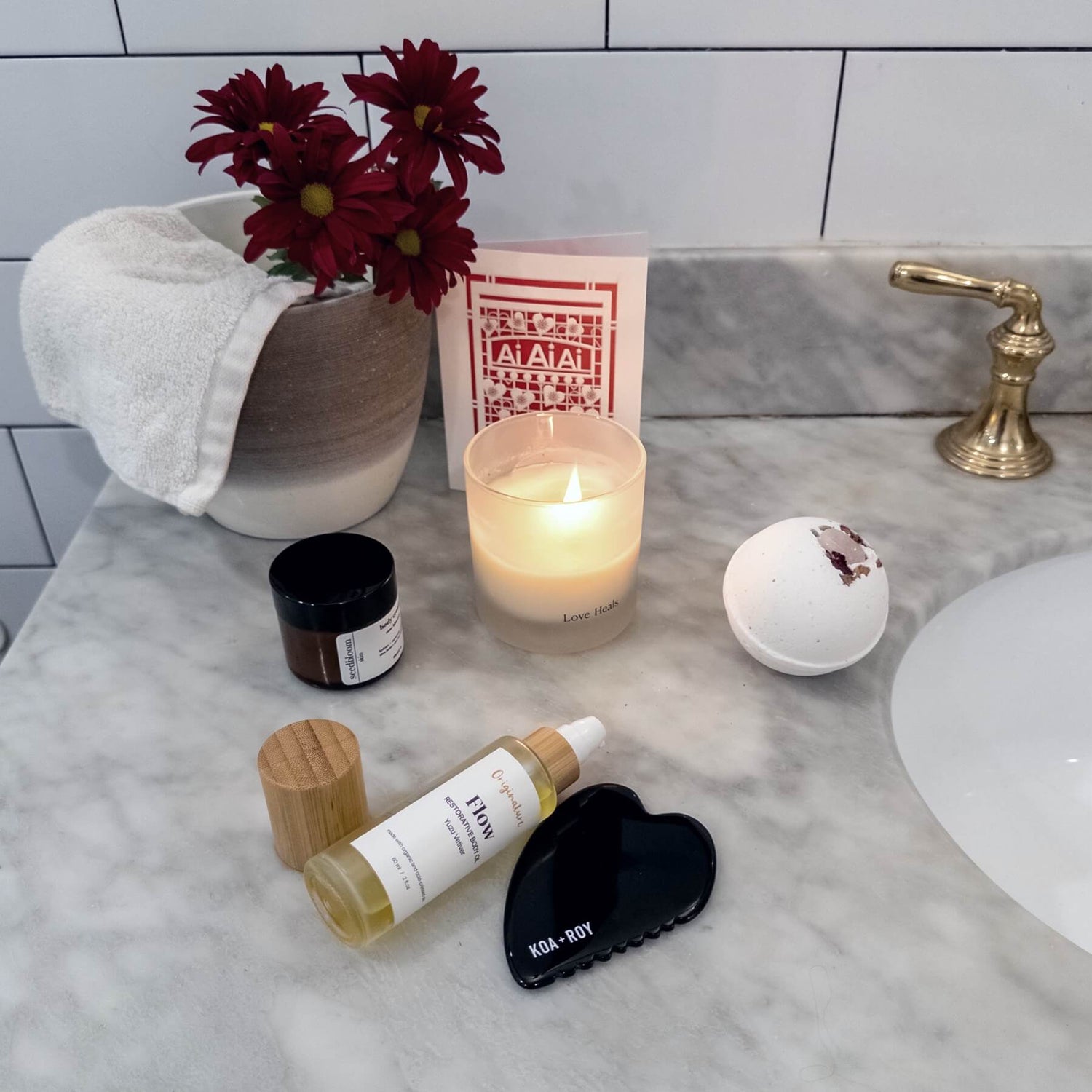 Valentine's Day Luxury Gift Set on the bathroom counter with candle, bath bomb, and skincare products