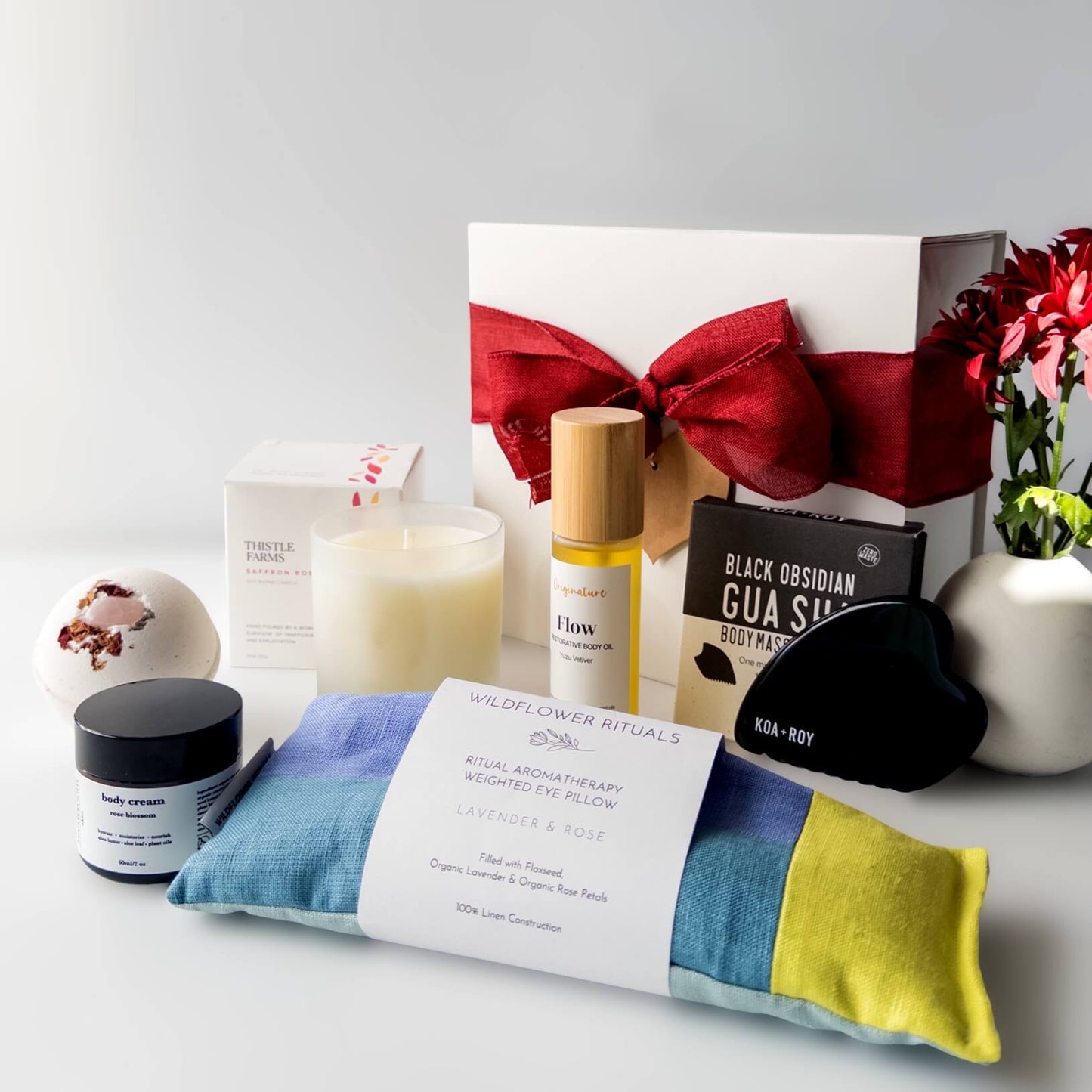 Luxury Spa Gift Box with candle, skincare products, and decorative items on a white surface.