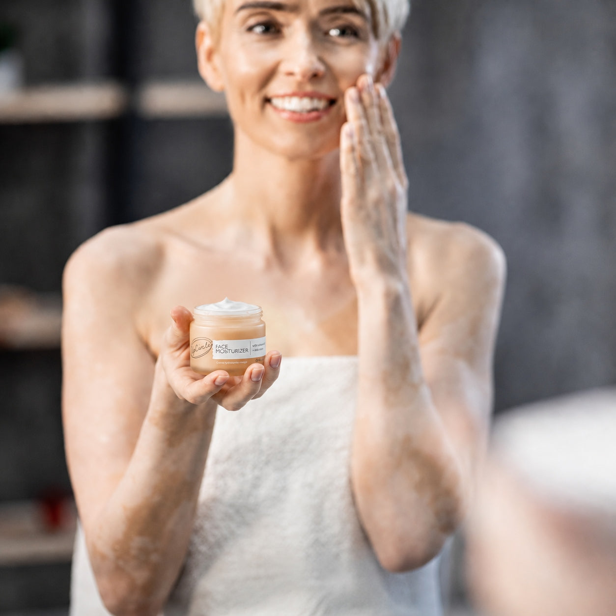 Woman using nourishing face cream as part of a fully restorative spa experience