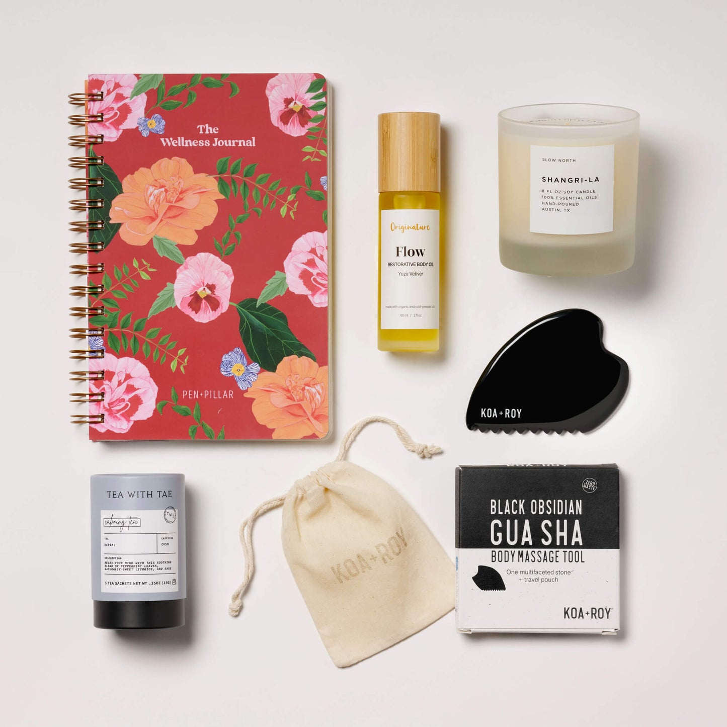 Stress relief gifts with journal, candle, tea, gua sha and body oil. 