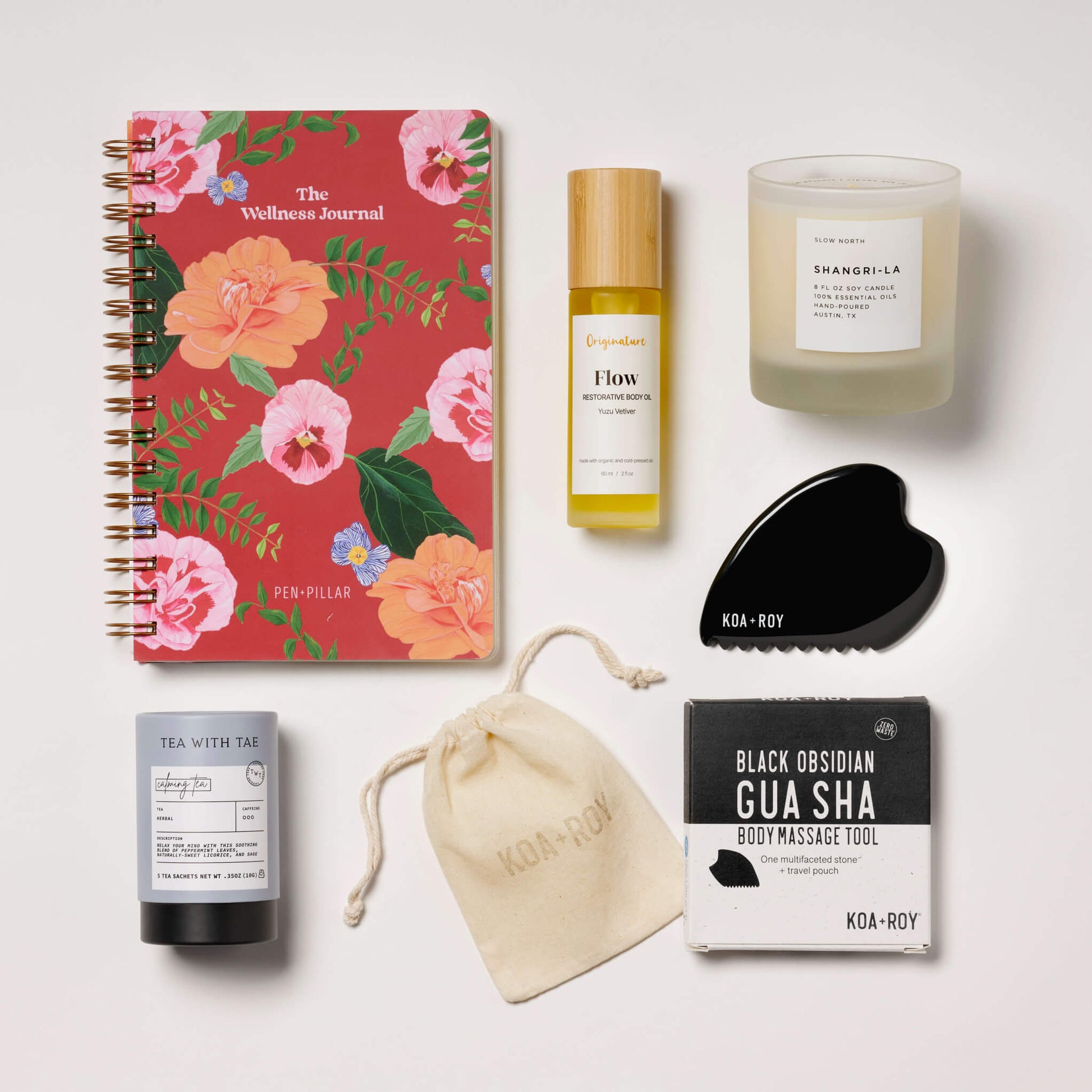 Stress relief gifts with journal, candle, tea, gua sha and body oil. 