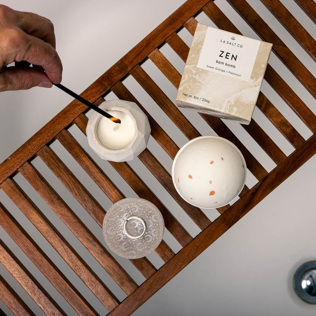 Zen bath bomb, small geodesic candle, and selenite crystal ring dish on tray over bathtub