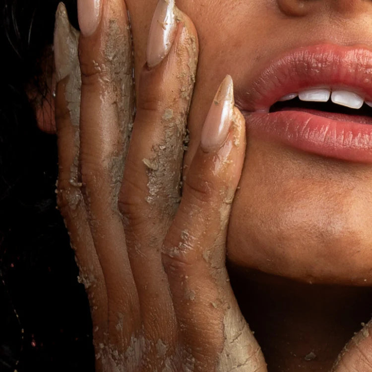 Woman using MILO Activating Powder to clean her face.