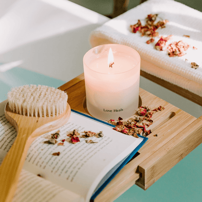 Saffron Rose candle on a ledge over a tub with book and scrubber