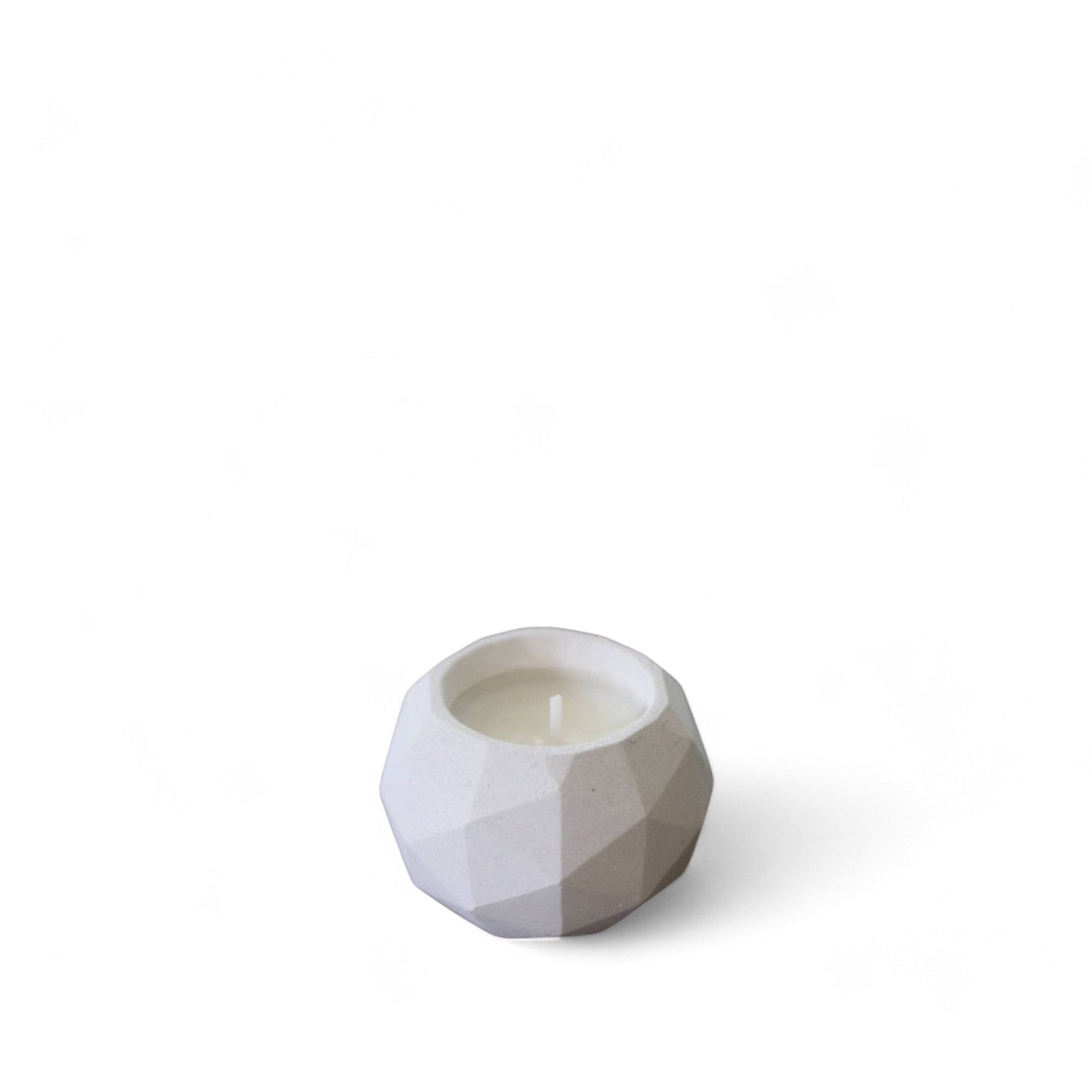 Small candle in geodesic cement holder